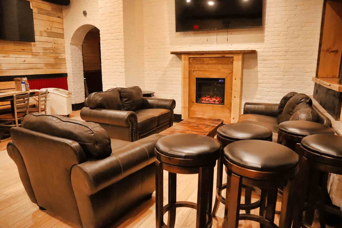 Lounge area with leather couches and fireplace